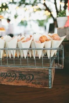 a bunch of food that is on top of a wooden box with some writing on it