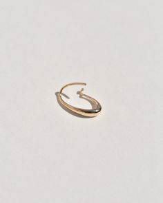 A semi-permanent style, the Sempre Hoop is part of a new offering of Leigh Miller that is designed to be worn everyday- or 'sempre'- which means always in Portuguese and Italian. This sculptural, solid gold hoop is intended to be put in, and never taken off. Wear it in the shower, in the pool or to sleep. Simply slide it in and fold the arm into its hook. Leigh was inspired to design this series to be the perfect huggers to compliment the rest of our sculptural earrings. The Sempre is ideal for Modern 14k Gold Oval Hoop Earrings, Modern Oval 14k Gold Hoop Earrings, Minimalist Oval Hoop Earrings With Polished Finish, Minimalist Gold Oval Hoop Earrings, Gold Minimalist Oval Hoop Earrings, Gold Oval Hoop Earrings Minimalist Style, Gold Oval Minimalist Hoop Earrings, Oval 14k Gold Hoop Earrings Timeless Style, 14k Gold Oval Hoop Earrings Timeless Style