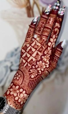 a woman's hand with henna on it