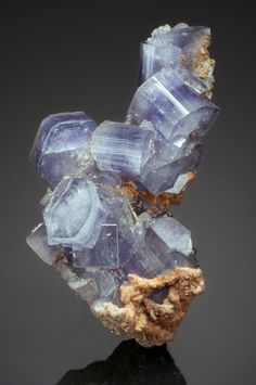 a cluster of crystals sitting on top of a black surface