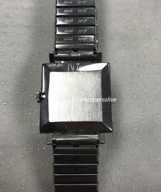 "For Sale: (1) Vintage Original Movado Switzerland Silver Tone Stretch Link Band Wrist Watch PLEASE READ ENTIRE DESCRIPTION BEFORE PURCHASING Pre-owned: Some scratches from normal wear. Face shows some discoloration. Please see photos for details. Watch is working and keeping time well. Watch is in great mechanical condition, all of our watches are tested for time by one of our watchmakers before being listed for sale. Specifics: *Movado *Hand-winding (mechanical) *silver tone bezel, case and br Silver Automatic Diamond Watch With Rectangular Dial, Rectangular Metal Dial Watch For Anniversary, Rectangular Automatic Watches For Anniversary, Rectangular Automatic Watch For Anniversary, Rectangular Watches With Date Display, Rectangular Watches With Date Display For Anniversary, Mechanical Hand, Authentic Watches, Filigree Ring