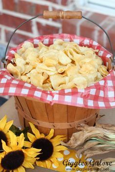 a basket filled with corn flakes sitting on top of a table next to sunflowers