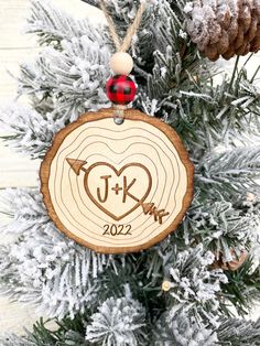 a wooden ornament hanging from a christmas tree with the initials j and r on it