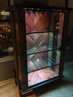 a glass display case sitting on top of a floor