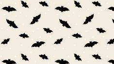 black bats are flying in the air on a white and beige background with tiny dots