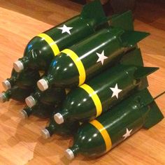 several green wine bottles with white stars on them sitting on a wooden floor next to each other