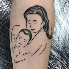 a black and white drawing of a woman holding a baby in her arms on the arm