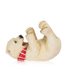 a white polar bear figurine wearing a red and white scarf