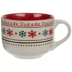 a red and white coffee cup with snowflakes on the side, sitting in front of a white background