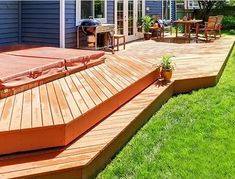 a wooden deck in front of a blue house