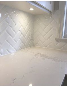 a kitchen counter with white tile on the backsplash