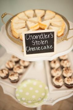 a table topped with lots of different types of cakes and cupcakes next to a sign that says chandler's stolen cheese cake