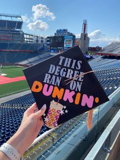 someone holding up a graduation cap that says, this degree ran on dunkin '