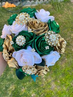 a bridal bouquet with green, white and gold flowers