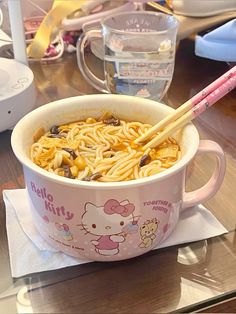 hello kitty ramen with chopsticks in a pink bowl on a wooden table