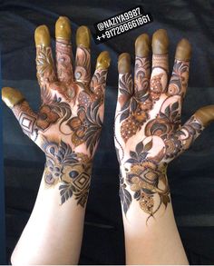 two hands with hendi designs on them