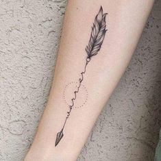 a small feather and arrow tattoo on the arm