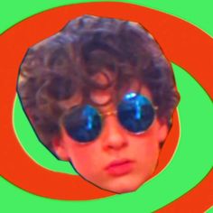 a young man wearing sunglasses and looking at the camera with an orange circle around him