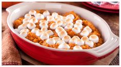 a red casserole dish with marshmallows in it