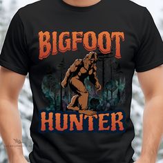 "This funny camping \"Bigfoot Hunter\" T-shirt is the perfect attire for campers with a sense of humor and a taste for adventure! Show off your love for the great outdoors and your playful side with this hilarious and eye-catching shirt. The \"Bigfoot Hunter\" Camping Shirt features a bold and attention-grabbing design that's sure to turn heads around the campfire. The shirt boasts a playful depiction of Bigfoot, the elusive forest-dwelling creature, holding a magnifying glass as if on a mission. The whimsical artwork is paired with fun, quirky typography that proudly declares you as a \"Bigfoot Hunter.\" It's a design that combines mystery and humor, making it perfect for those who enjoy camping and a good laugh. This classic unisex jersey short sleeve tee fits like a well-loved favorite. Quirky Typography, Bigfoot Funny, Bigfoot Hunter, Funny Camping, Around The Campfire, Whimsical Artwork, Camping Humor, Magnifying Glass, Camping Shirt