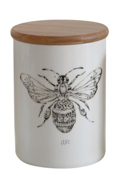 a ceramic jar with a drawing of a bee on it