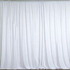 a white curtain is hanging on the wall