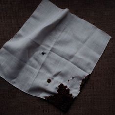 a piece of cloth that has been left on the floor with some dirt in it