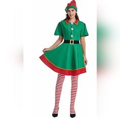 a woman dressed in a green christmas elf costume with red and white striped stockings, holding her hands on her hips