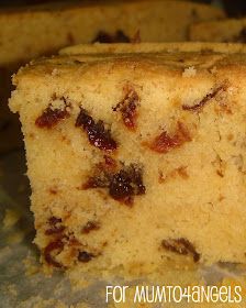 a piece of cake sitting on top of a counter next to other pieces of bread