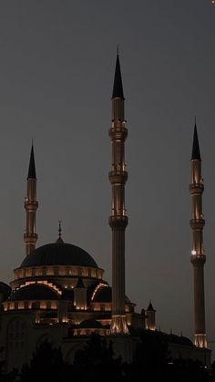 an airplane flying over a large building at night