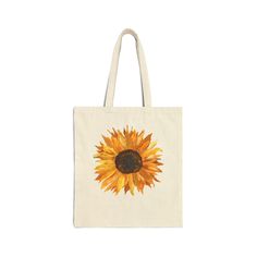 Floral Sunflower Canvas Tote Bag.  Heavy canvas bag perfect for so many uses: school bag, work bag, reusable grocery tote, library bag, and more.  This bag showcases a watercolor painting of a single sunflower by Susan Curtis.  This 100% cotton bag comes in one size - 15" x 16". 100% heavy cotton canvas is durable and will last for years. The bag features 20" handles (made from the same canvas), making it easy to carry even with a week's worth of shopping. There are other similar bags available at LoneFirArtisans.Etsy.com Custom requests gladly accepted.  Shipping time will be longer. All of my items contain only my art, not purchased or downloaded from someone else.  Check out other items in my store: https://www.LoneFirArtisans.Etsy.com Sunflower Tote Bag, Single Sunflower, Library Tote, Gift For Gardener, Sunflower Canvas, Library Bag, Canvas Making, Grocery Tote, Watercolor Sunflower