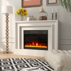 a living room with a white fireplace and black and white rugs on the floor