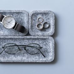 two square trays with glasses, watch and ring