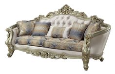 an ornate couch with many pillows on the top and bottom, sitting in front of a white background