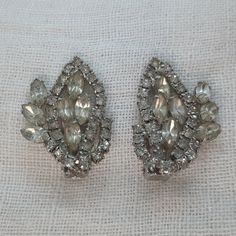 We love the size of these vintage rhinestone statement earrings. The 1950s retro earrings are made in a large paisley shape and sit approximately 1.5" tall x 1" wide. They are well-made with prong-set rhinestones and clip on backs. Vintage Clip-on Earrings For Wedding, Vintage Crystal Clip-on Earrings For Wedding, Vintage Silver Bridal Earrings For Formal Occasions, Silver Vintage Bridal Earrings For Formal Occasions, Vintage Jeweled Clip-on Earrings For Wedding, Vintage Silver Jeweled Clip-on Earrings, Silver Vintage Clip-on Earrings For Vintage Events, Vintage Jeweled Crystal Earrings For Formal Occasions, Vintage Jeweled Crystal Earrings For Formal Events