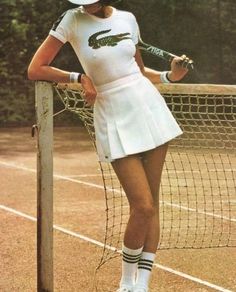 a tennis player poses with her racket on the court