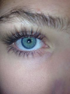 a woman's blue eye with long lashes