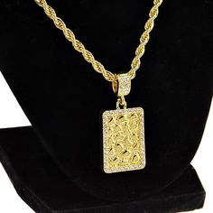 Get your shine on with a square nugget design pendant rope chain necklace. Twisted rope chain is 24" long x 4 mm wide, stylish lobster claw clasp closure. Square nugget pendant is approx 21MM wide x 29MM tall, encrusted with round cut stones around the perimeter. Yellow gold finish over a high quality base metal core, chunky piece weighs 40 grams. Enjoy 100% FREE SHIPPING in the USA. Rectangular Pendant Necklace With Box Chain, Rectangular Chain Necklace For Gift, Gold Rectangular Chain Necklace, Metal Core, Gold Rope Chains, Rope Chain Necklace, Gold Nugget, Hip Hop Jewelry, Pendant Gold