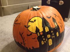 a decorated pumpkin sitting on top of a floor