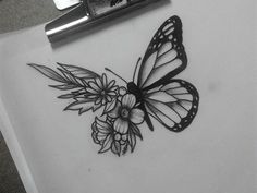 a black and white photo of a butterfly with flowers on it's back side