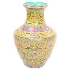 a large vase with colorful designs on the outside and inside, sitting against a white background