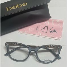 a pair of glasses sitting on top of a table next to a wallet and eyeglass case