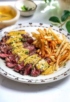 steak and french fries on a white plate