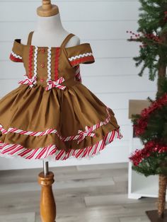 Girls Gingerbread Dress Adorable girls Gingerbread Dress! Features fun trim and a cute off the shoulder style. Large bow ties in back. Cookie Costume Diy, Whoville Costumes, Xmas Clothes, Ballet Outfits, Girls Sewing Projects, Cookie Costume, Girls Christmas Dress