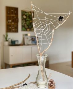 a spider web in a vase on a table