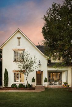 a white house with trees in front of it