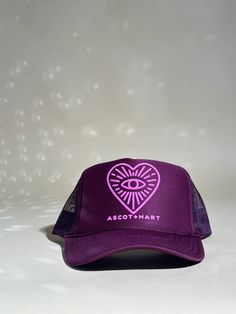 The perfect trucker.  100% Polyester Front; 100% Nylon Mesh This hat is made to order and will ship in 3-5 business days MADE TO ORDER PRODUCTS ARE FINAL SALE Purple Trucker Hat With Curved Brim, Pink Embroidered Trucker Hat, Purple Trucker Hat One Size, Navy Embroidered Logo Trucker Hat, Trucker Hat With Embroidered Logo, One Size, Heart Eye, Heart Eyes, Trucker Hats, Trucker Hat