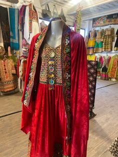 Experience the vibrant charm of our Kuchi 3-Piece Dress!  It's carefully made from the luxurious Bakhmal fabric. The dress is alive with colorful mirror embroidery, giving a playful and lively feel to the classic design. The set includes: Qamees (Shirt): Fashioned from Bakhmal fabric for comfort and opulence. Shalwar (Pants/Trouser): A perfect complement, tailored for ease and elegance. Dupatta (Shawl): Adorned with lively hand embroidery, adding a splash of color and charm. Whether for festive Bohemian Traditional Wear With Dabka For Ceremonies, Bohemian Embroidered Dress With Dupatta For Navratri, Navratri Bohemian Embroidered Dress With Dupatta, Bohemian Salwar Kameez With Traditional Drape For Festival, Traditional Dabka Embroidered Dress With Drape, Traditional Embroidered Dabka Dress With Drape, Bohemian Embroidered Dress With Dabka For Festive Occasions, Traditional Embroidered Dabka Dress, Bohemian Multicolor Embroidered Dupatta With Dabka