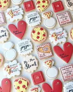 decorated cookies are arranged in the shape of hearts and pizza slices with words on them