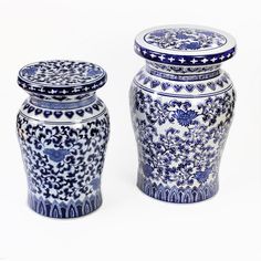 two blue and white vases sitting next to each other on a white table top